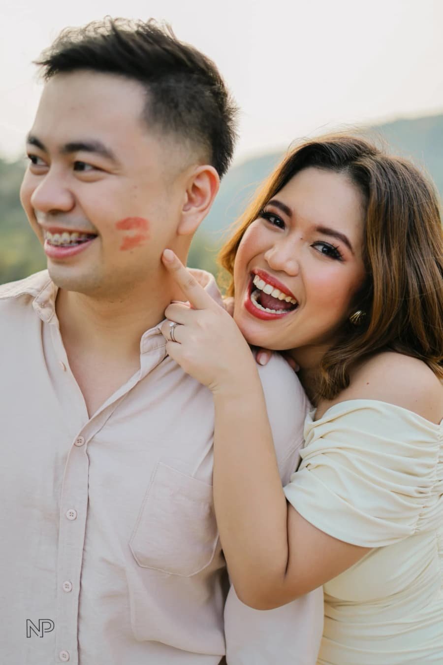 Chanel laughing at the lipstick mark she left on Nelson's cheek
