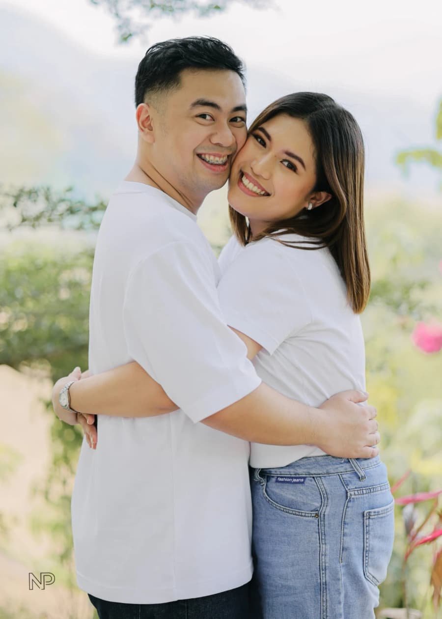 Nelson and Chanel laughing in a close embrace