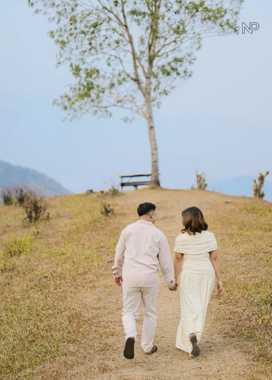 Nelson and Chanel walking hand in hand up the hill