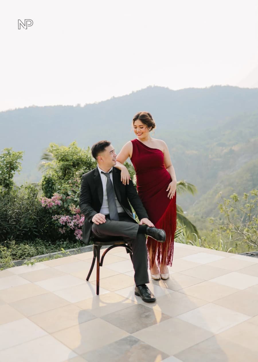 Nelson seated with Chanel beside him, the hills behind them